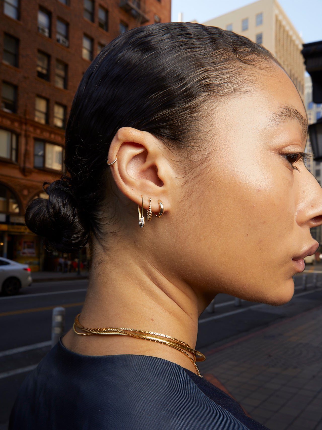 14k Gold Bubbled Hollow Hoops pictured on models ear in second piercing.