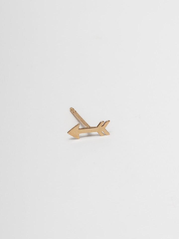 14kt Yellow Gold Mini Cupid Arrow Stud pictured on light grey background. 