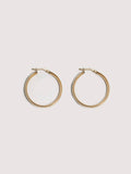 14kt Yellow Gold Hollow Tube Hoops pictured on light grey background.