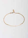 14kt Yellow Gold Eastsider ID Bracelet pictured on light grey background from above.