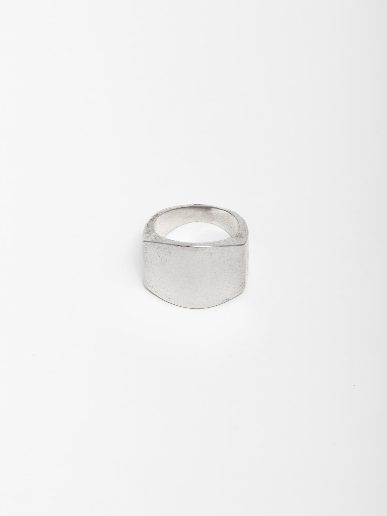 Sterling Silver ID Ring pictured on light grey background.