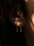 14kt Yellow Gold Gem Bezel Hoop Charms pictured on models ear. Charms are shown on the Elfin Huggies.  