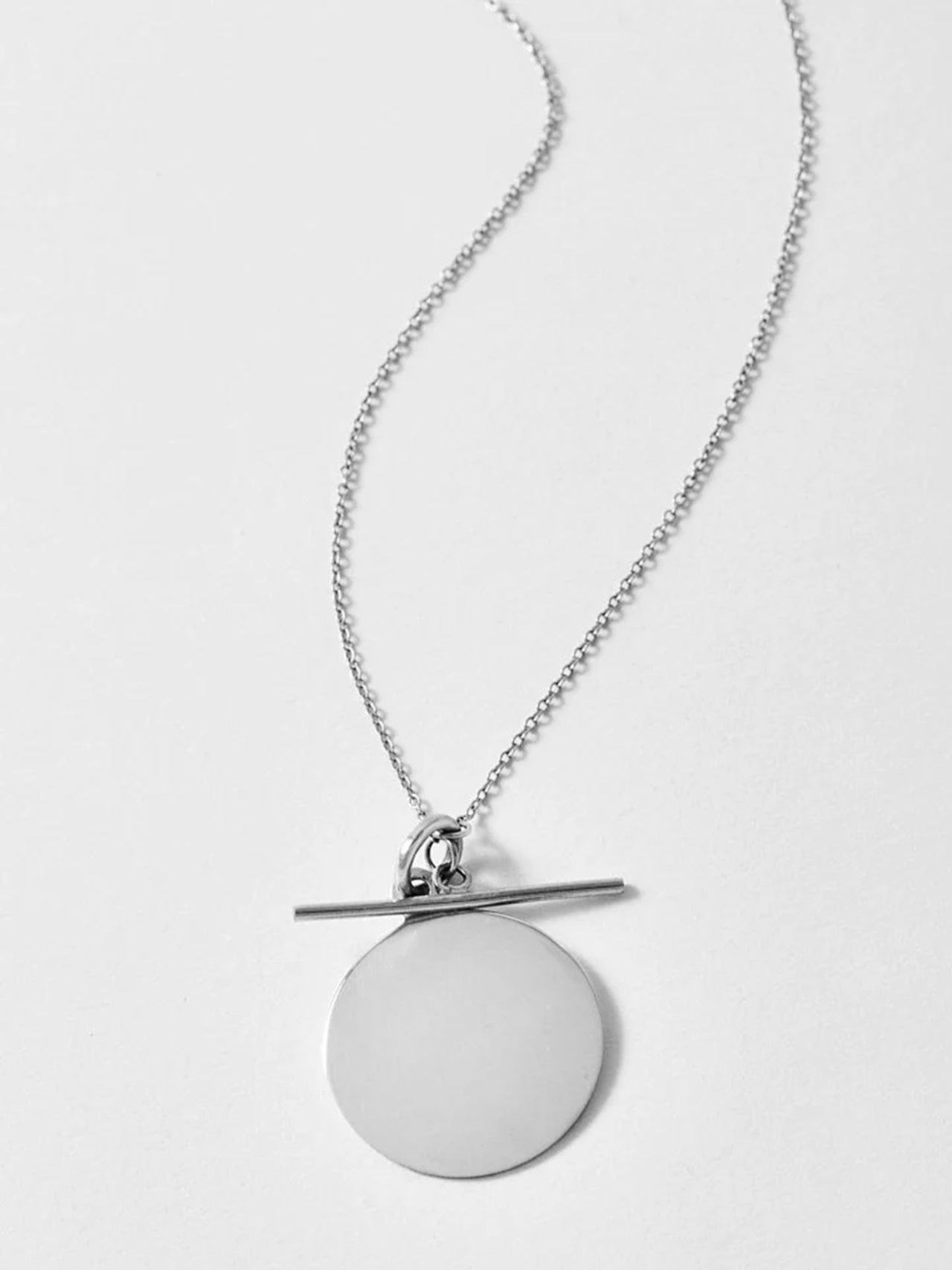 Sterling Silver Disk and Toggle pictured on light grey background.