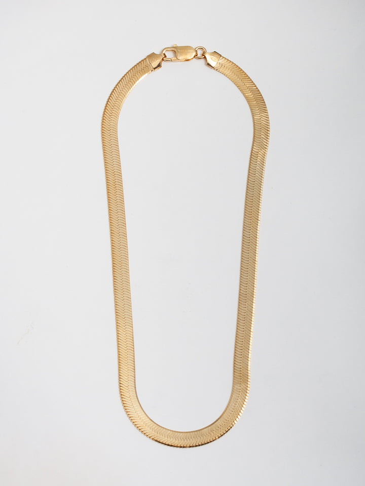 Vermeil XL Herringbone Necklace pictured on light grey background.