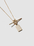 Klint ID & Toggle Necklace in 14k yellow gold pictured on light grey background.