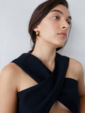 Vermeil Midi XL Dome Hoops pictured on model.  Light grey background.
