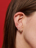 14kt Yellow Gold Solo Sparkle Huggie pictured in models third piecing. Along with the Pierced and Petite Pave Huggies. 