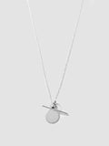 Silver necklace with a round pendant on a light gray background
