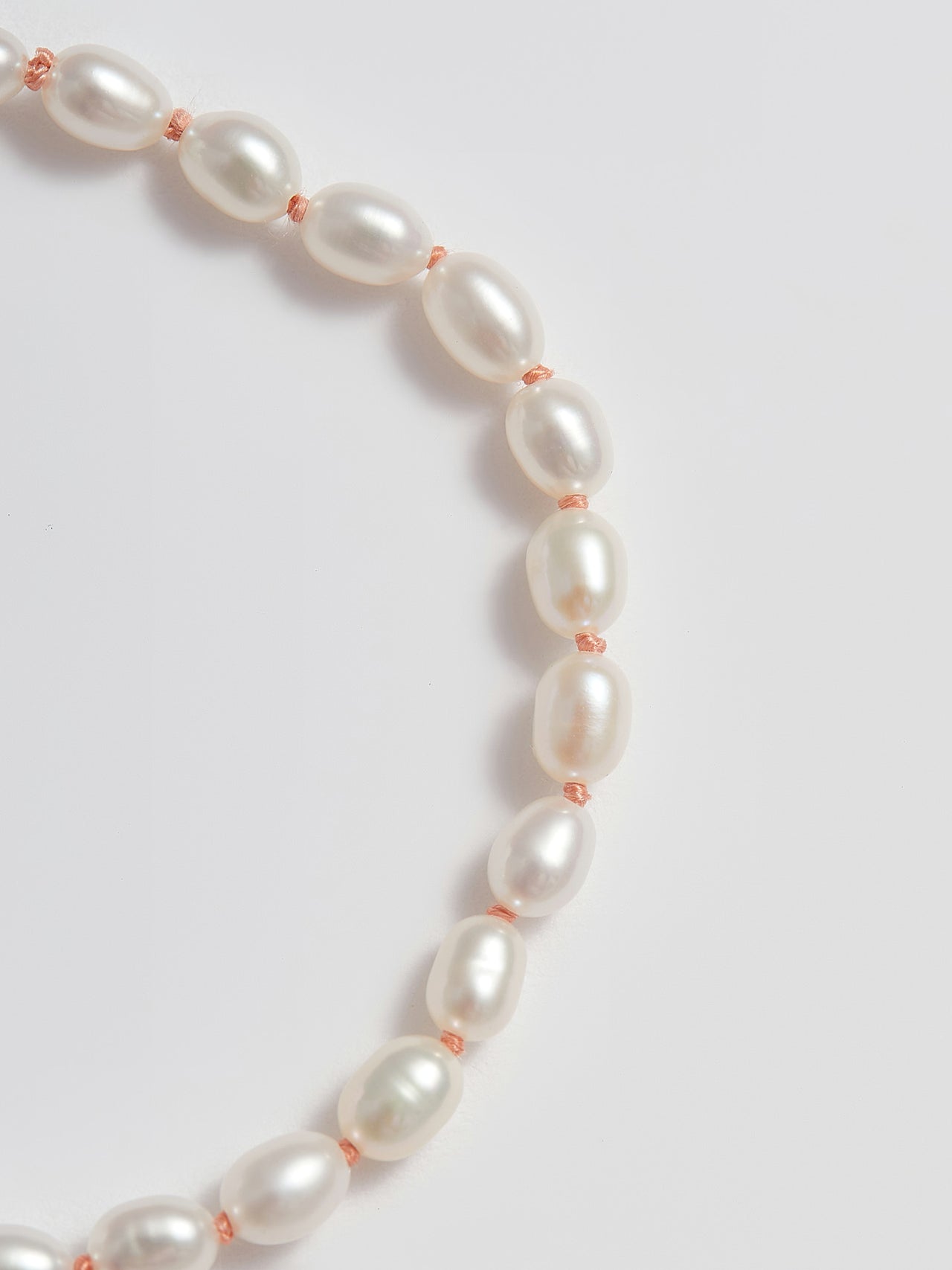 Close up of Freshwater Pearls and Pink String 