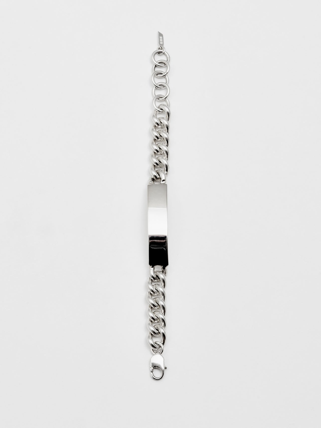 Sterling Silver Solid Curb Chain ID Bracelet shot laying vertical on light grey background. 