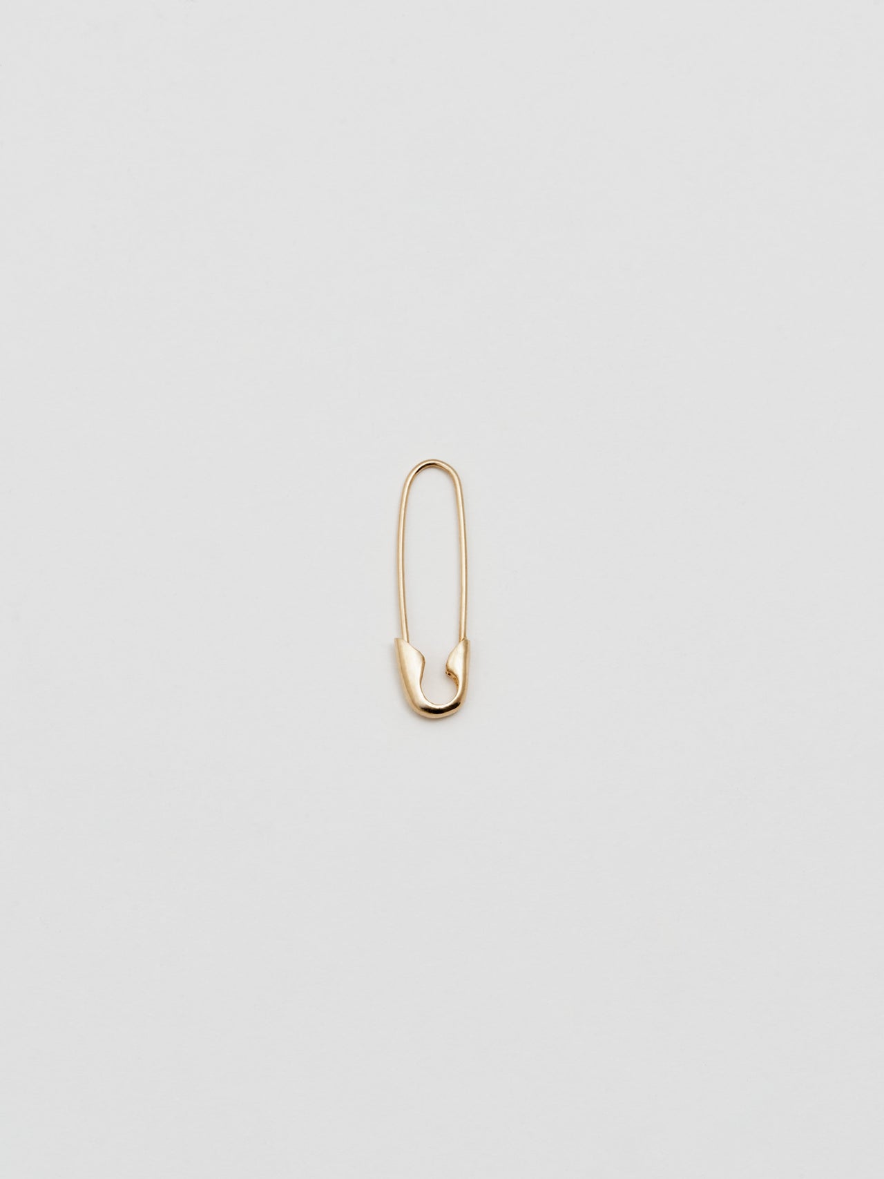 Product shot of the Safety Pin Earring (14Kt Shiny Yellow Gold Safety Pin Earring  Length: 21.35mm) Background: Grey backdrop