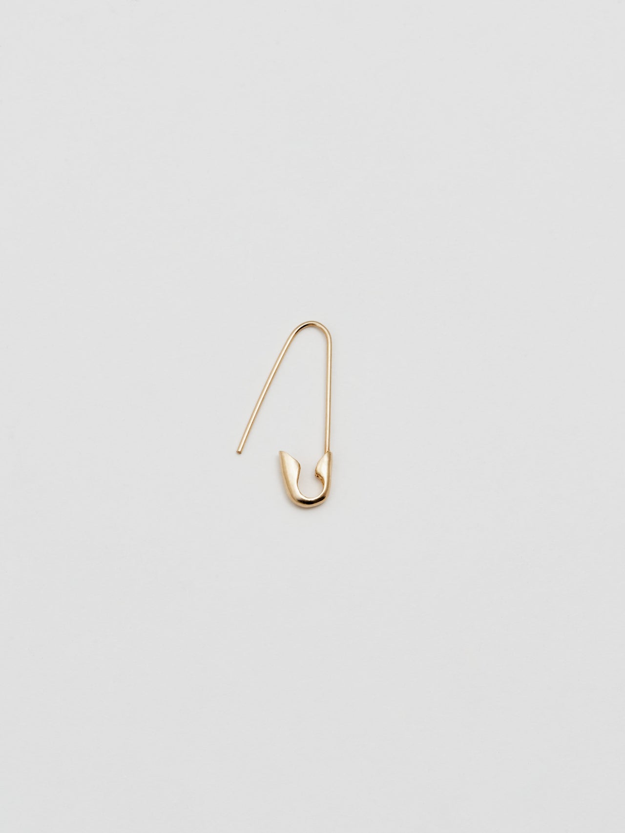 Detail product shot of the Safety Pin Earring on clasped (14Kt Shiny Yellow Gold Safety Pin Earring Length: 21.35mm) Background: Grey backdrop