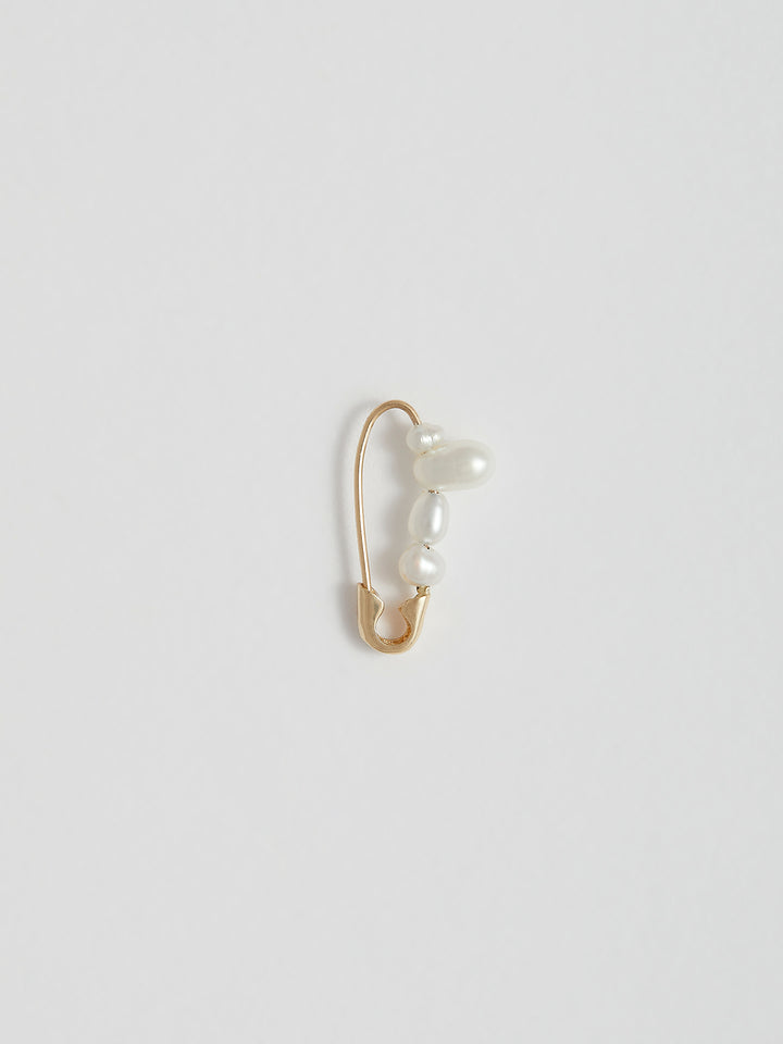 Product shot of the Mini Mixed Pearl Safety Pin Earring (14kt Yellow Gold Mixed Pearl Safety Pin Length: 17mm Mixed Freshwater Pearls) Background: Grey Backdrop