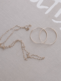 14Kt Yellow Gold Ultralight Infinity Hoops flat lay image.