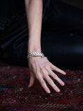 Flat Curb Chain bracelet pictured on models wrist. 