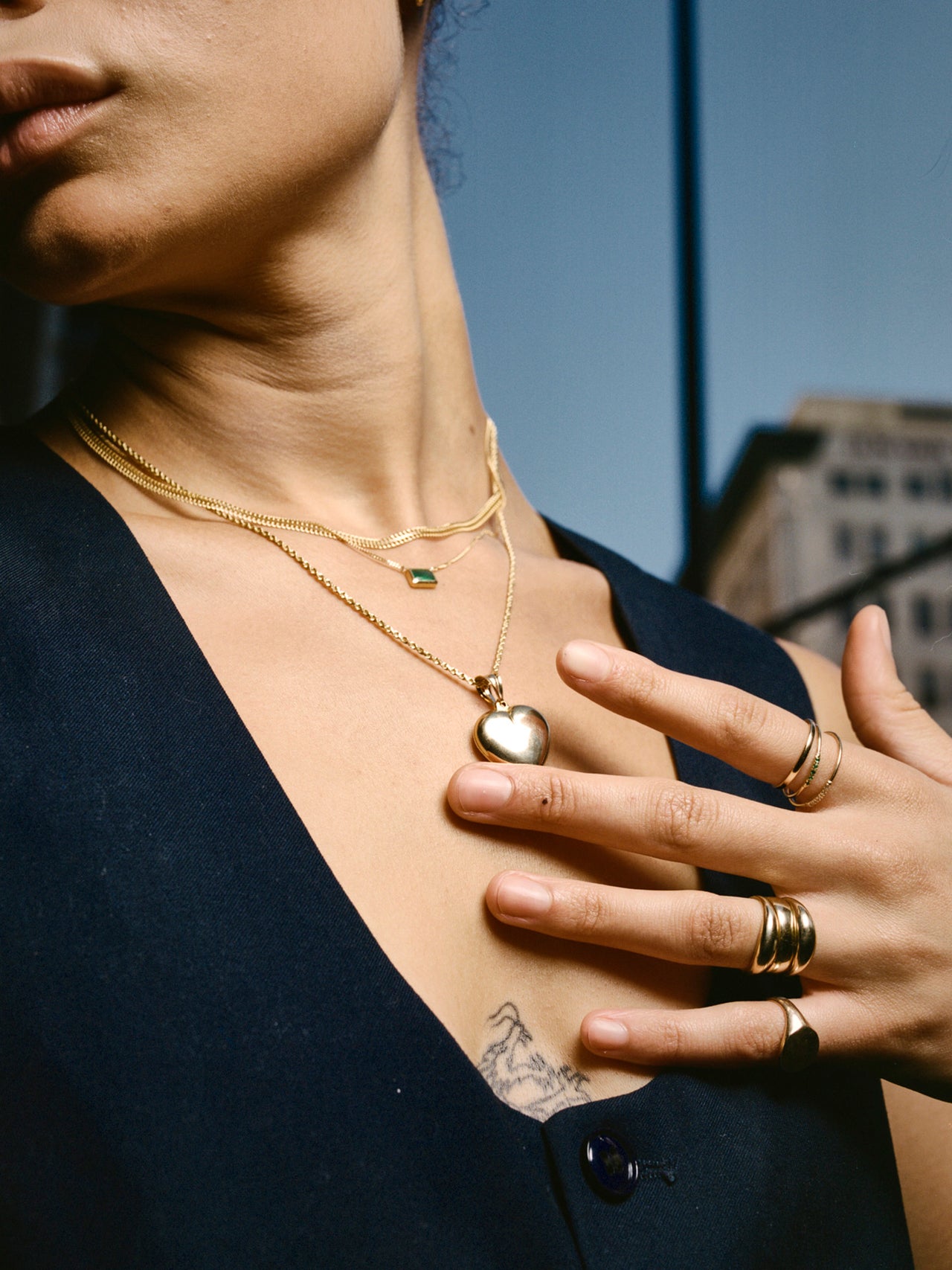14kt Yellow Gold XL Puff Heart Pendant pictured on model. Strung on the Solid Gold Rope Chain.