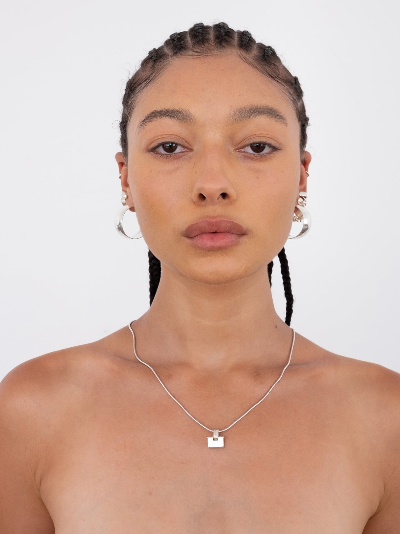 Sterling Silver Padlock Bolo Chain Necklace pictured on model. Light grey background.