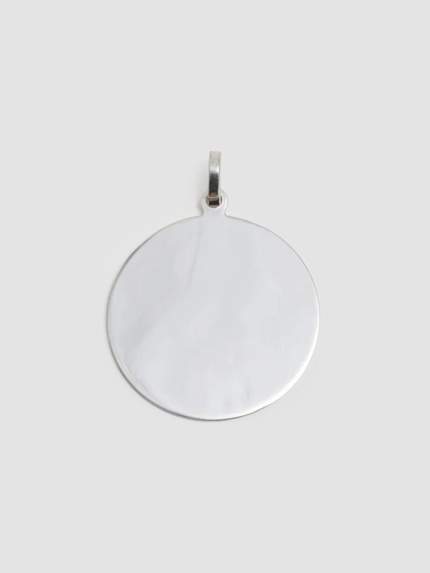 Silver pendant on a white background