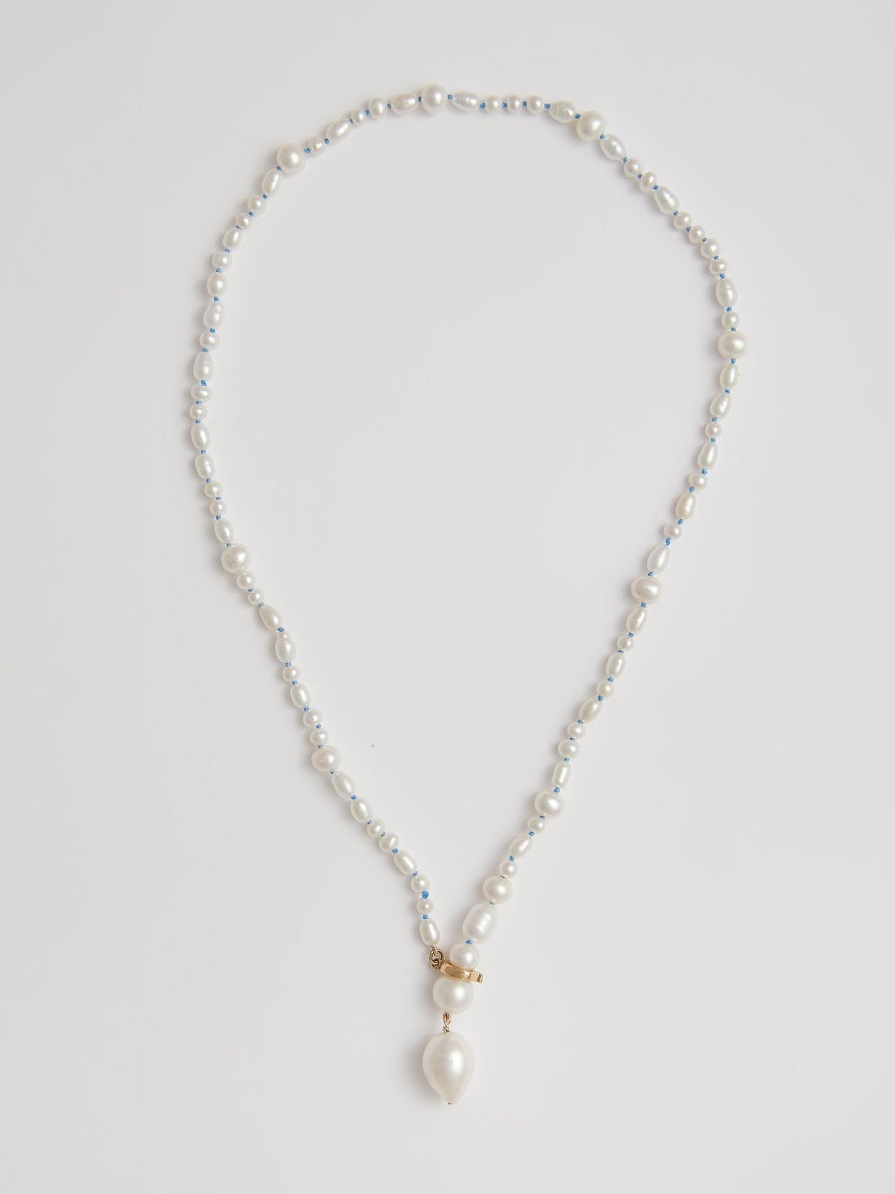 14kt Yellow Gold Pearl Necklace pictured on light grey background.