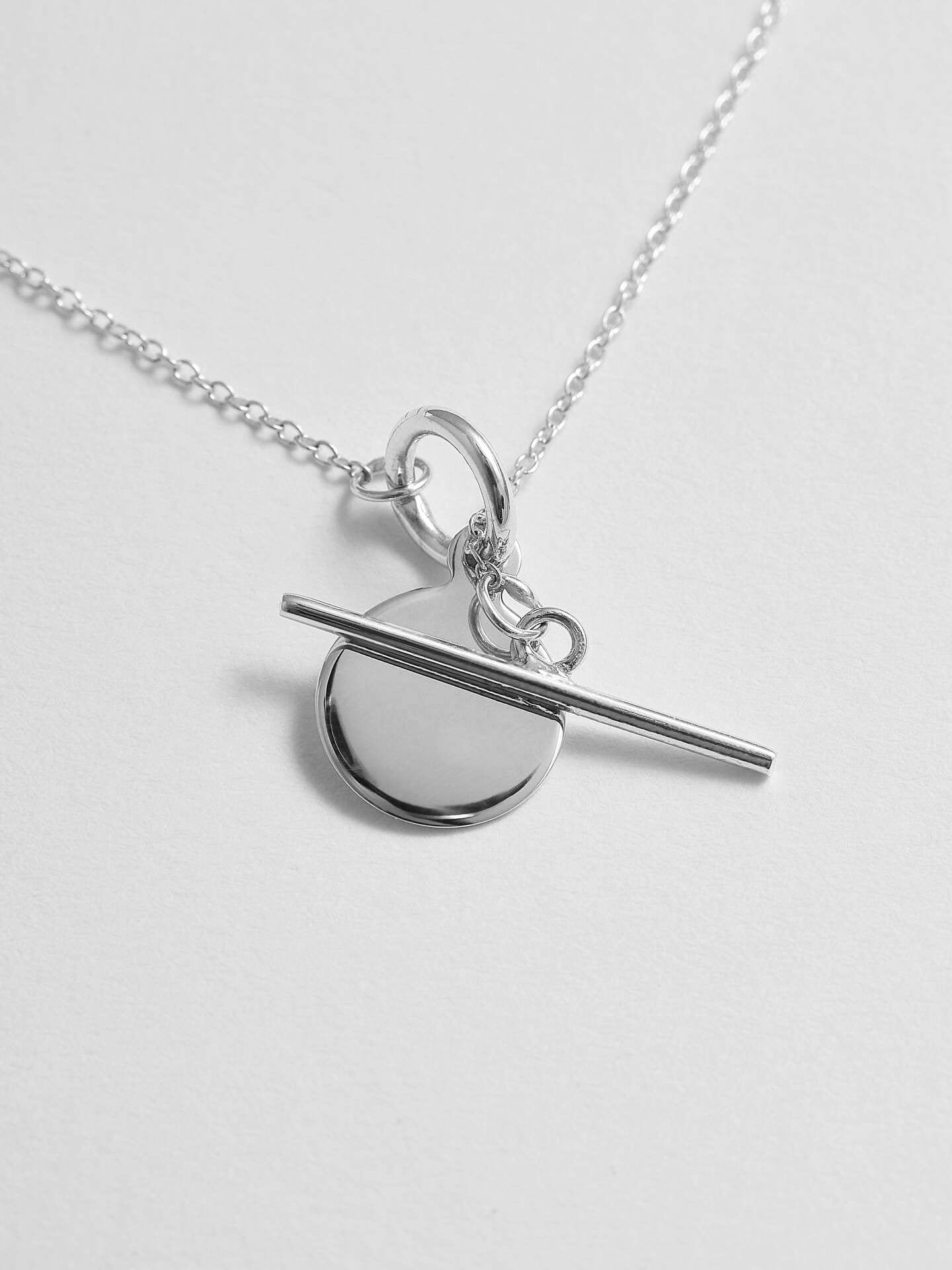 Close up shot of Sterling Silver Mini Disk and Toggle Necklace.