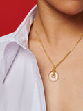 14Kt Yellow Gold Square Wheat Chain & Quartz Pendant Necklace pictured on model. red background.