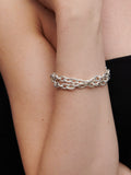 Sterling Silver Rumi Wrap pictured as bracelet on models wrist. 