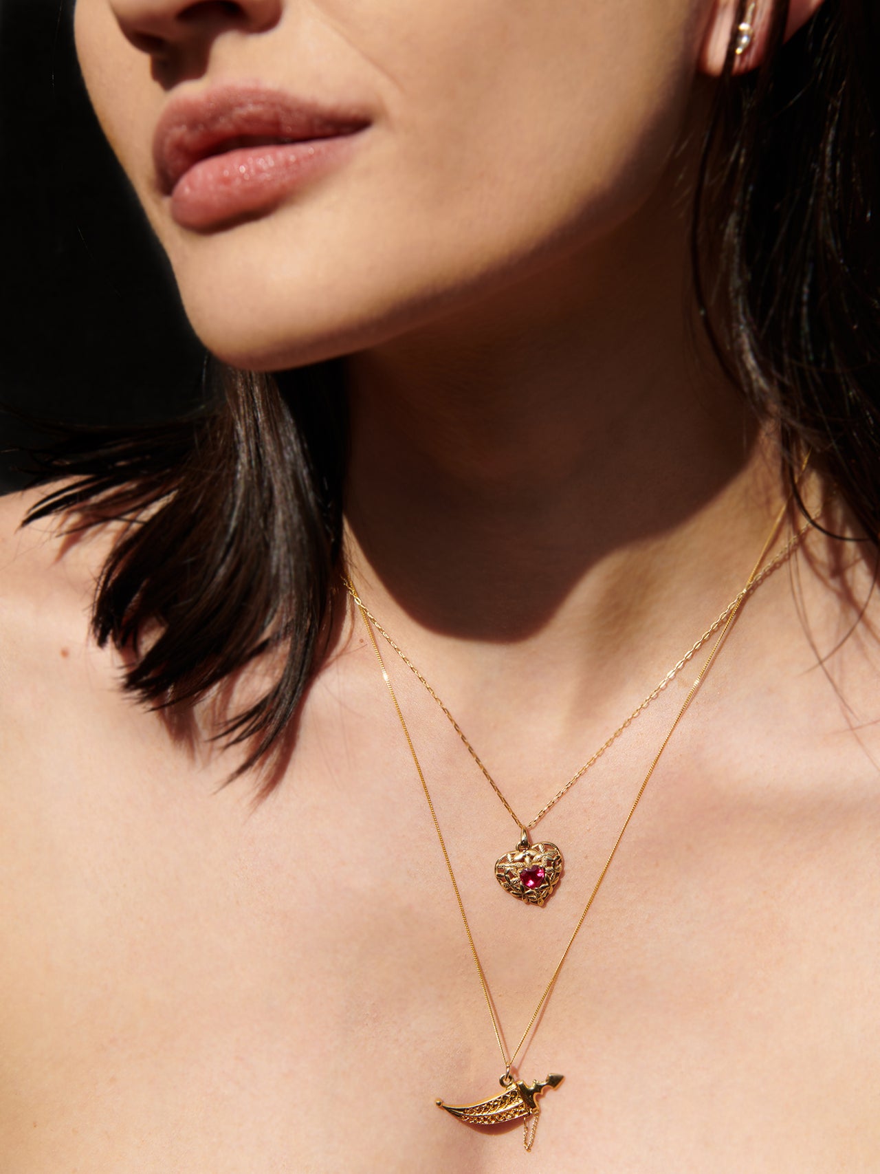 14Kt Yellow Gold Heart Gemstone Pendant Necklace pictured on model. Black background. 