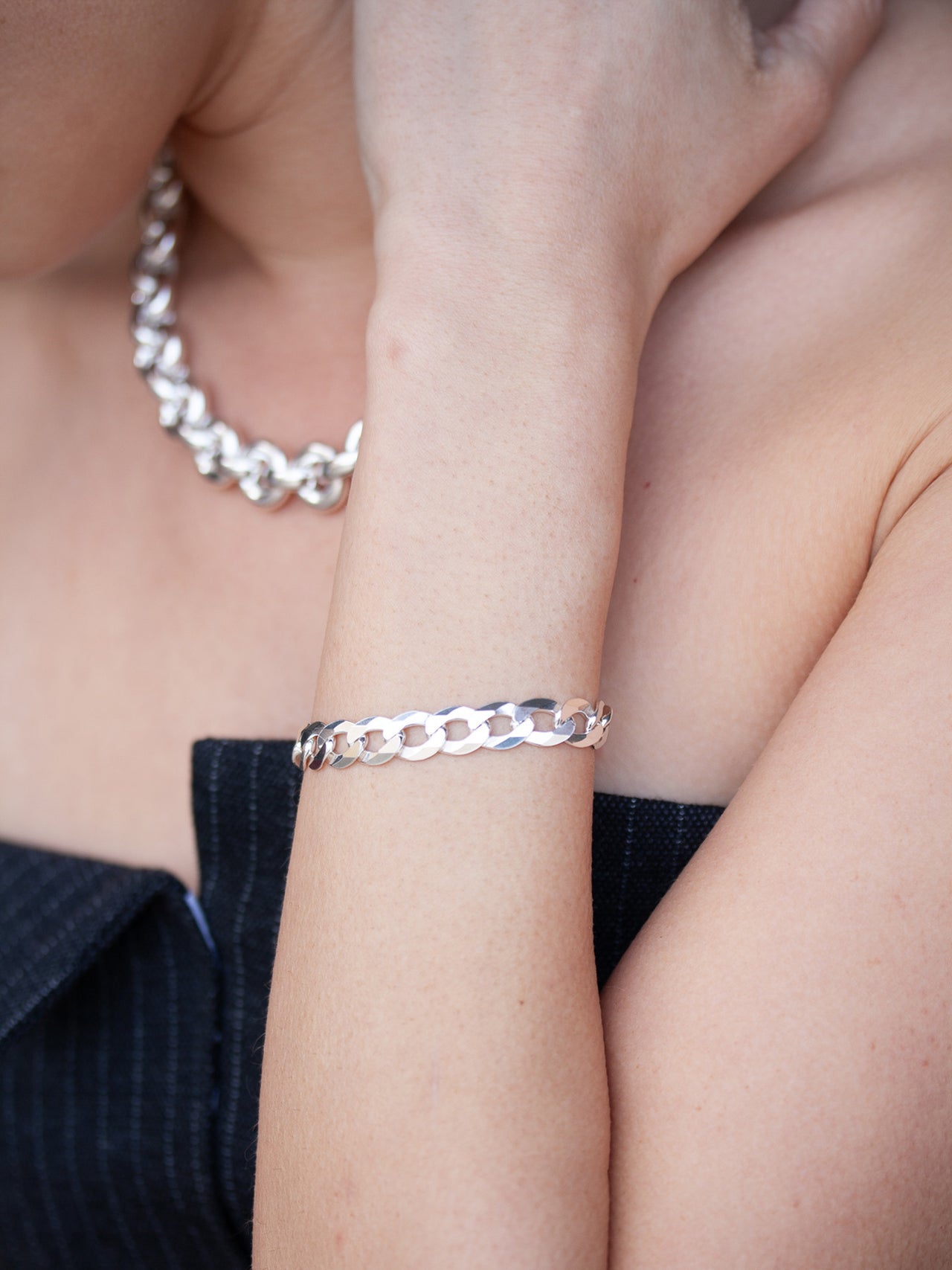 Sterling Silver Flat Curb Chain pictured on models wrist. 