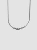 Silver necklace with a clasp on a light gray background