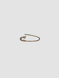Gold safety pin on a white background