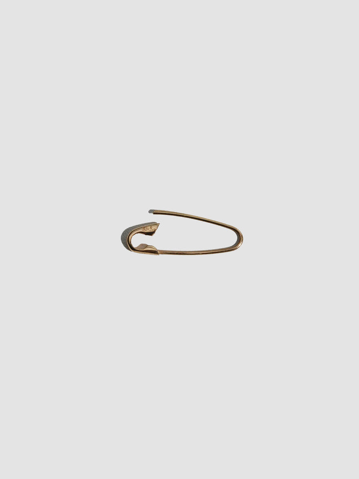 Gold safety pin on a white background