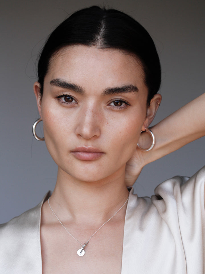 Medium Sterling Silver Tru Hoops pictured on model. 