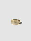 Gold ring on a light gray background