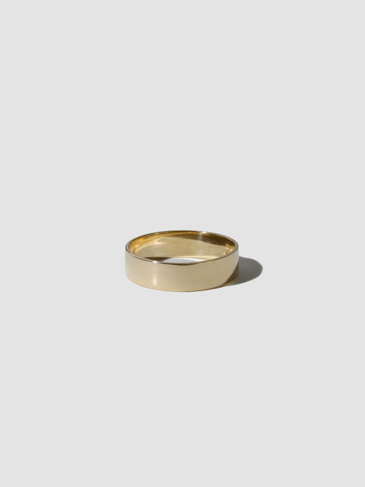 Gold ring on a light gray background