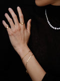 14kt Yellow Gold Valentino Chain Bracelet pictured on models wrist. 
