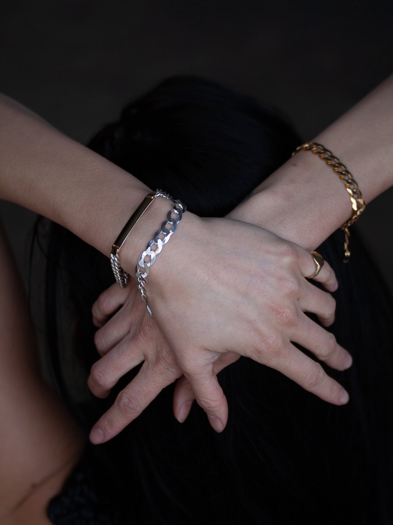 Flat Curb Chain Bracelet pictured on models wrist. 