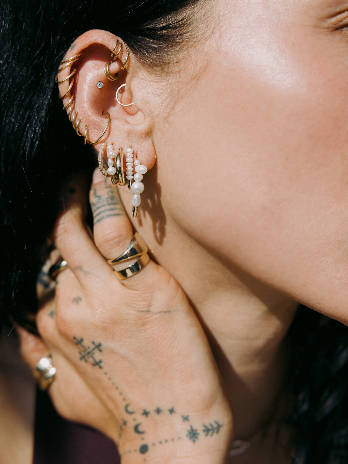 Mixed Pearl Safety Pin Earring pictured in models first piercing. Styled with other best selling styles.