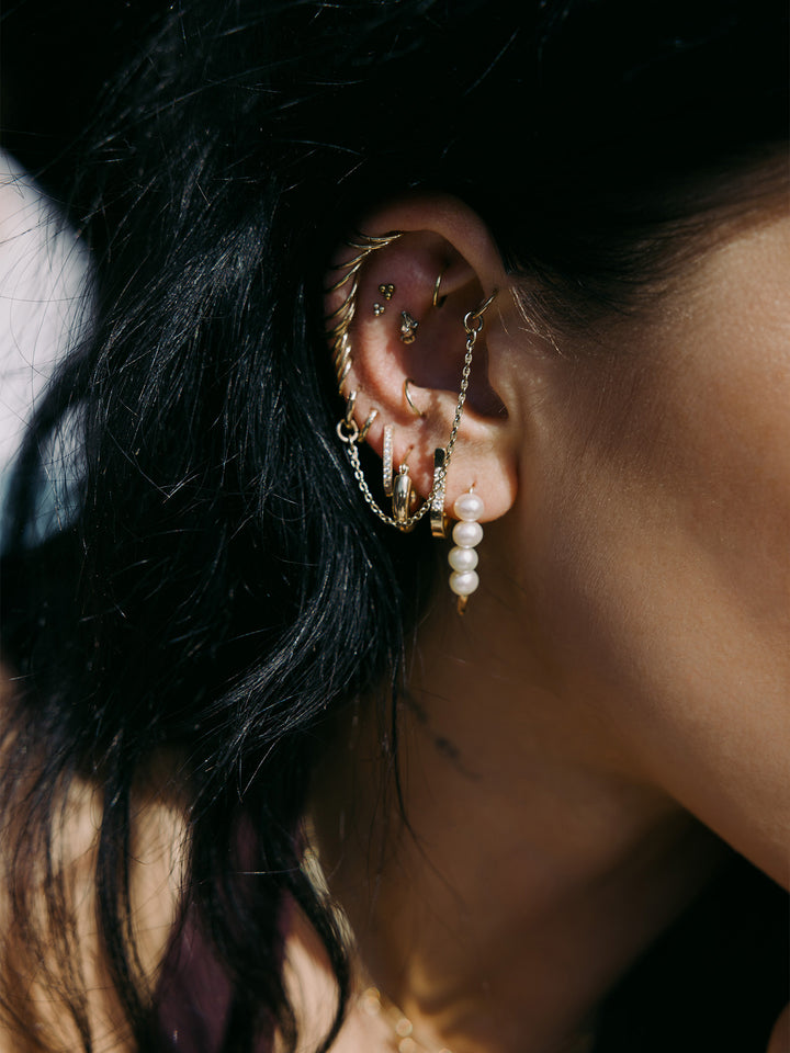  XL Pearl Safety Pin Earring pictured in models first piercing. 