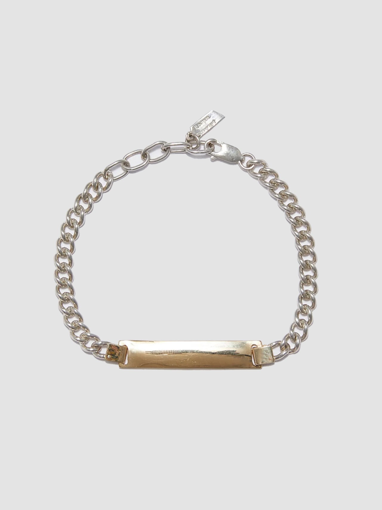 Watts ID Bracelet: Sterling Silver Curb Chain with a 14Kt Gold ID Centerpiece Length: 7’ (adjustable)
