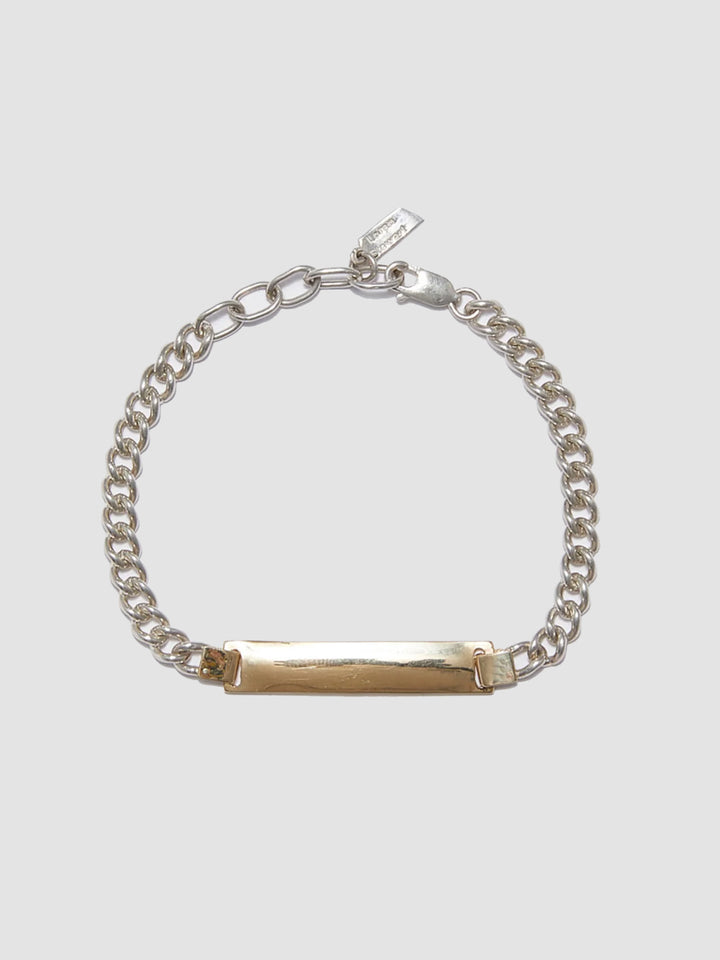 Watts ID Bracelet: Sterling Silver Curb Chain with a 14Kt Gold ID Centerpiece Length: 7’ (adjustable)