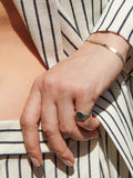 Eastsider Bracelet shot on model with sterling silver baby signet.