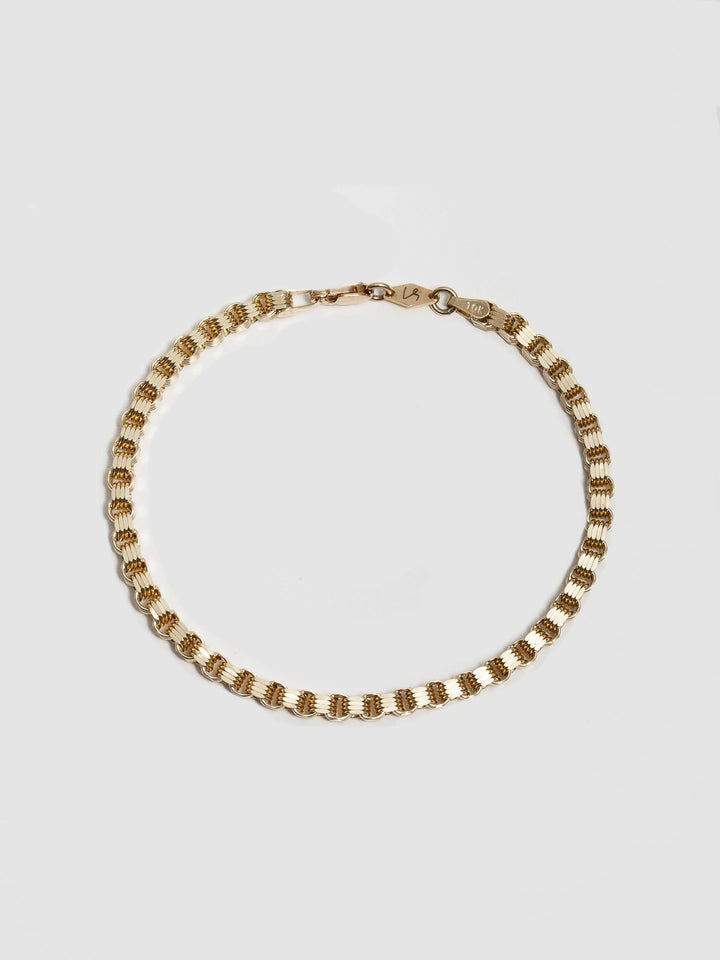 10kt Yellow Gold Mini Alexander Chain Bracelet pictured on light grey background.