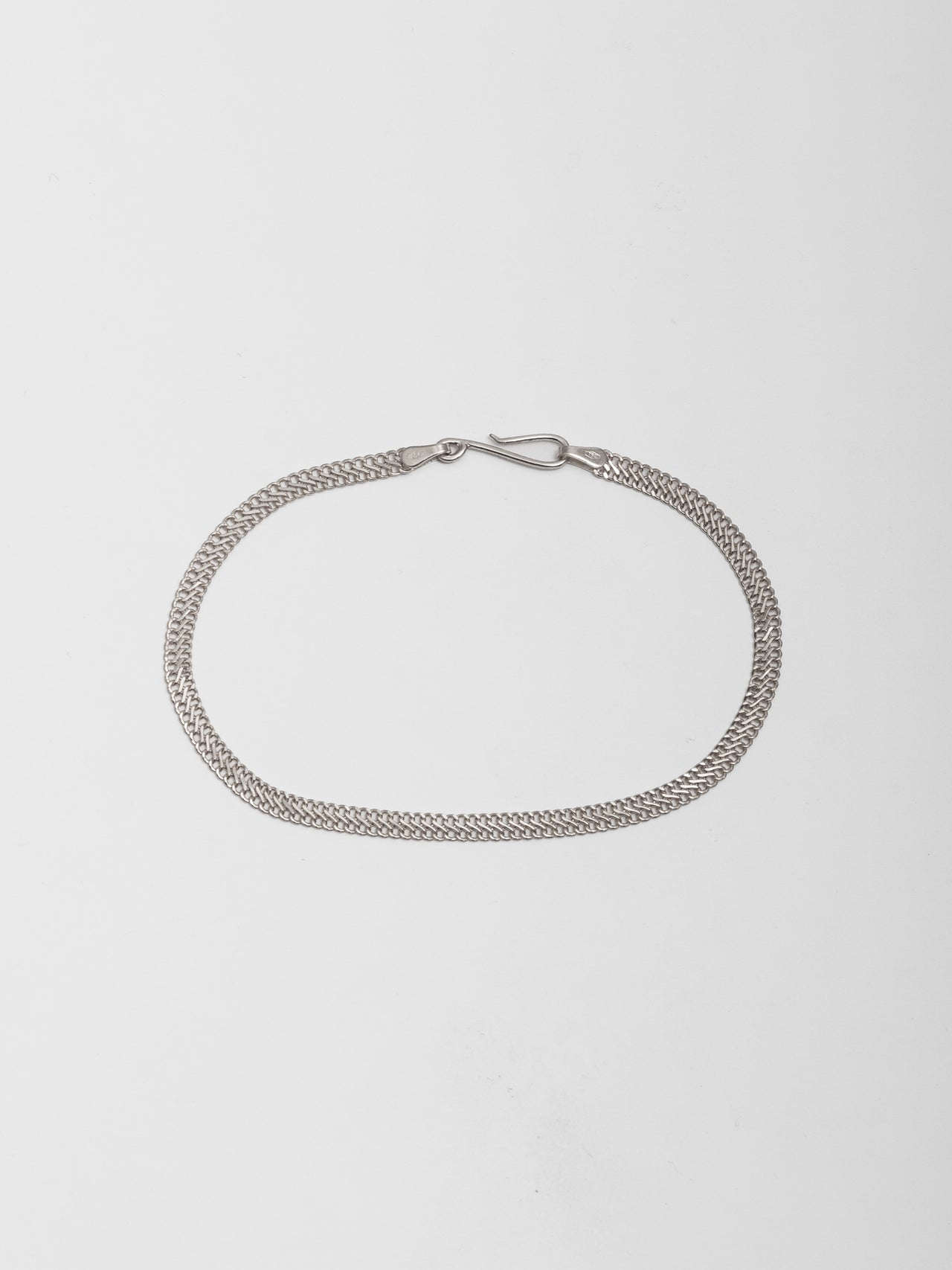 Sterling Silver Mesh Chain Bracelet pictured on light grey background.  