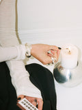 Sterling Silver Hollow Dome Cuff pictured on models wrist who is lighting a candel. 