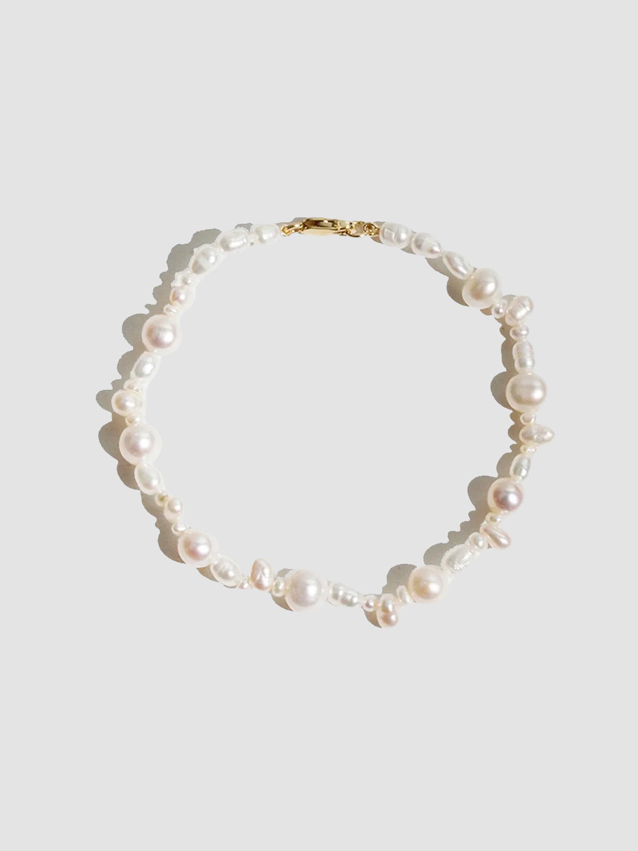 14kt Yellow Gold Bellissimo Pearl Bracelet pictured on light grey background.