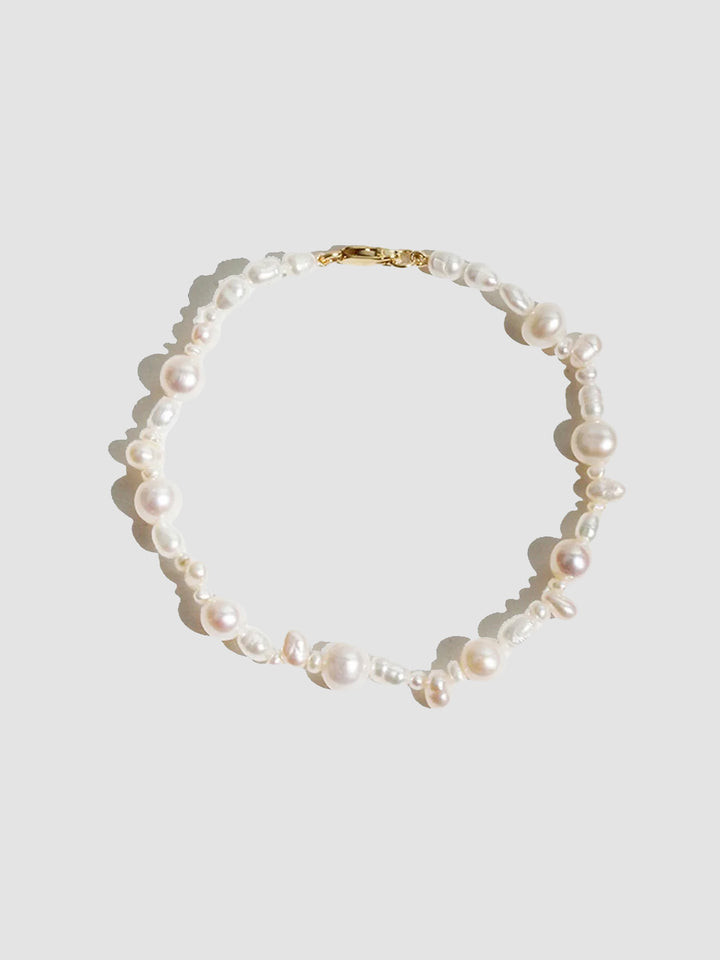 14kt Yellow Gold Bellissimo Pearl Bracelet pictured on light grey background.