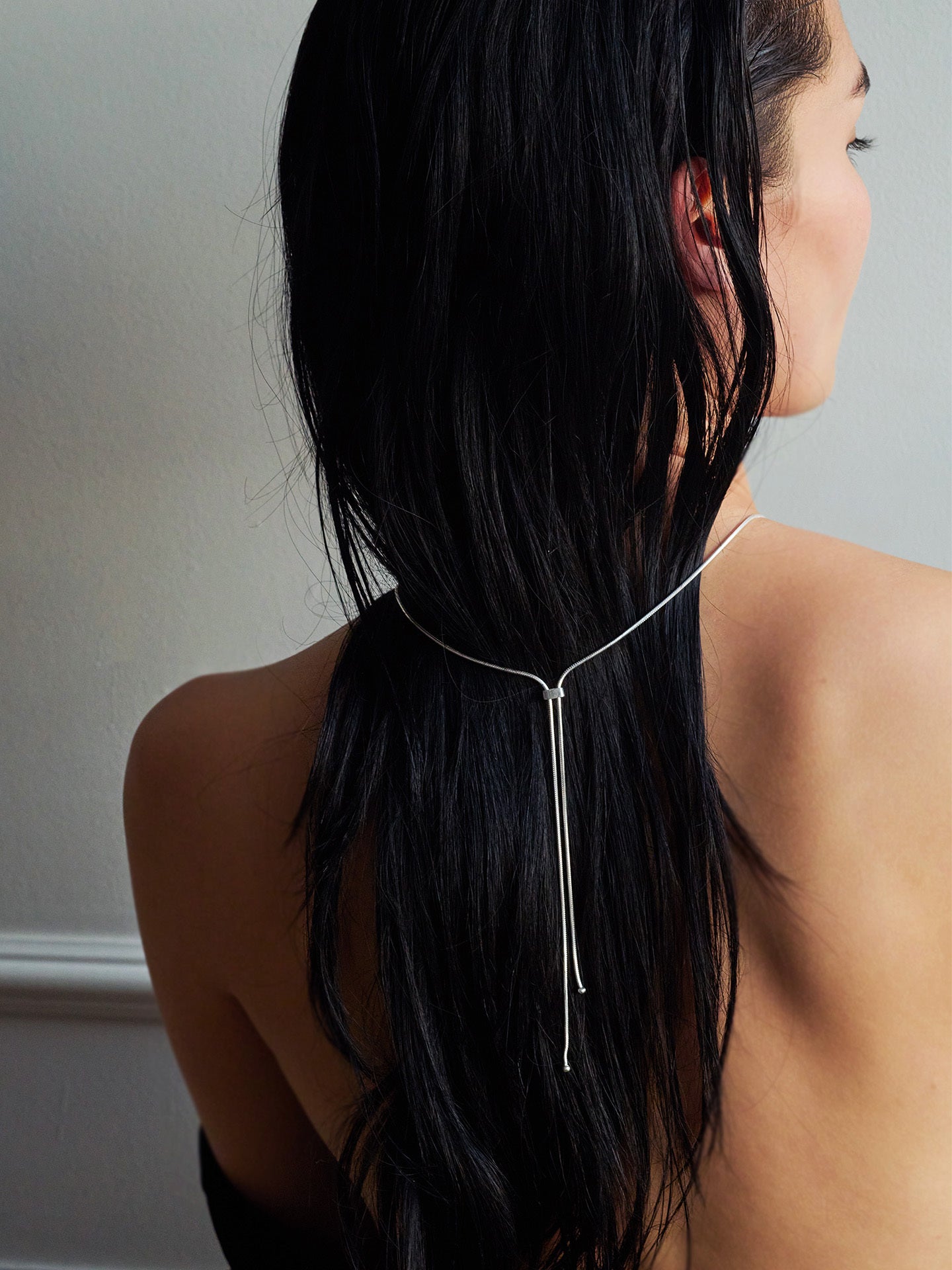 Sterling Silver Bolo Pendant Necklace pictured on model. Light grey background.