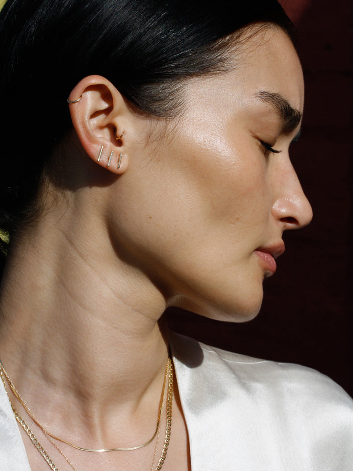 Diamond rod stud pictured in models second piercing. 