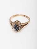 14kt Yellow Gold Diamond & Sapphire Ring shot on white background.