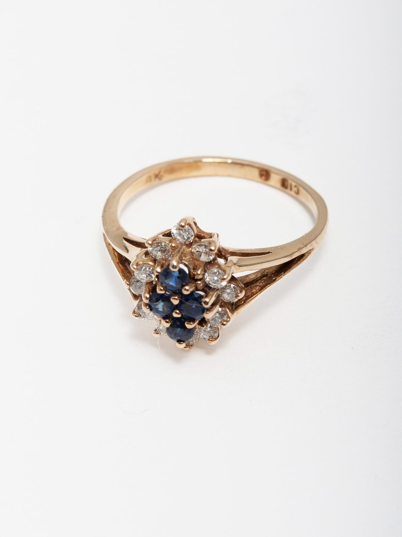 14kt Yellow Gold Diamond & Sapphire Ring shot on white background.